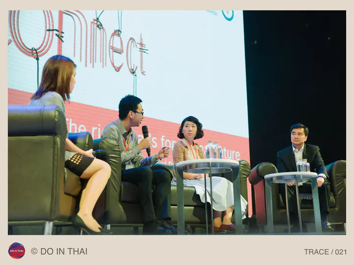 Four panellists sit on a stage, facing one another in conversation.